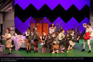Princess Penelope (Samantha Blaine) sleeps while the drama camp ensemble - holding twisty, thorny vines - prevent Prince Albert (Jackson Wells-Benitez) from reaching Penelope.