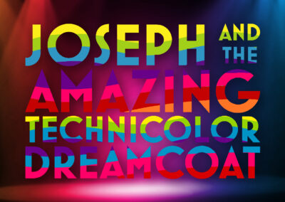 Joseph... Dreamcoat logo featuring rainbow text over a background of bold, colorful stage lights.