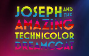 Joseph... Dreamcoat logo featuring rainbow text over a background of bold, colorful stage lights.