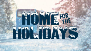 Home for the Holidays logo graphic featuring blue block letters covered in snow in front of an image of a bus driving through a wintery landscape.