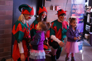 Santa's helpers in the lobby greeting kids and families.