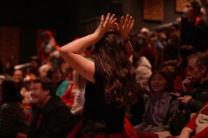 Kids in the audience participating in the Reindeer Games, a coin toss elimination with only one winner.