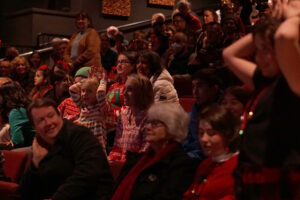 Kids in the audience participating in the Reindeer Games, a coin toss elimination with only one winner.