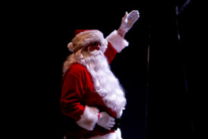 Santa Claus entering the theatre to great applause.