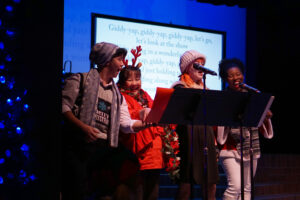 Cast members singing another Christmas carol.