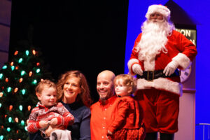 Santa posing with a family for a photo.