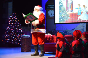 Santa reading The Nutcracker Prince to the audience.