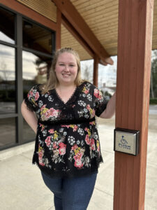 Photo of Brooke Larson in front of the New Stage entrance.