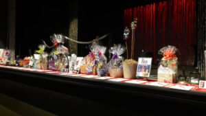 What to find at the gala: Auction baskets full of things to bid on lined up across the front of the stage.