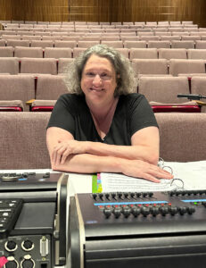 Kristeen Willis behind her desk at the Deb Fennell Auditorium, designing lights for Joseph.