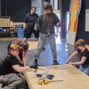 Photo of stagehand interns building a platform for Joseph and the Amazing technicolor Dreamcoat.