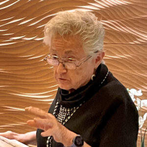 Photo of Judy Koonce volunteering at the check-in counter at Broadway Rose.