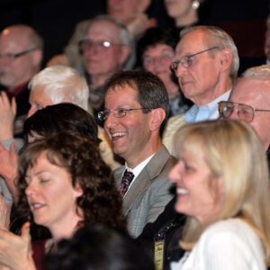 Photo of laughing audience members.