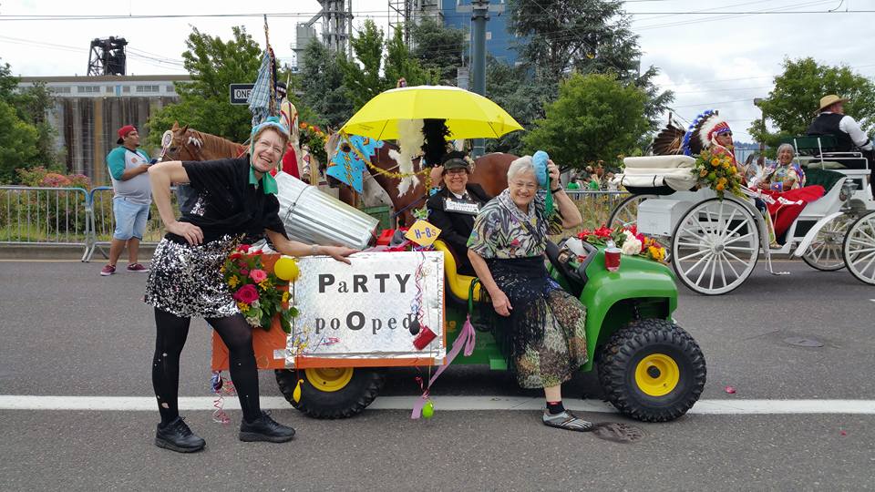 Judy Koonce - Pooper Scooper Photo of Judy and friends in the Pooper Scooper mobile in a local parade.