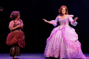 Production photo - Marie and Cinderella singing.