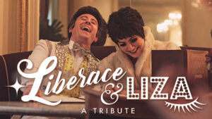 Photo of David Saffert and Jillian Snow as Liberace and Liza Minelli as they sit in a classy 1970s decorated lounge. The lights are low with a golden hue. The two of them are smiling and laughing with each other. The logo for the show is superimposed over them, reading Liberace and Liza, a tribute.