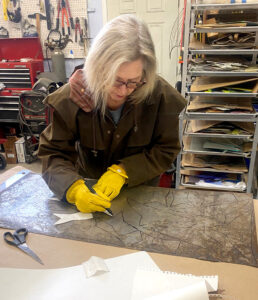 Photo of Cindy Geffel hard at work on another new piece.