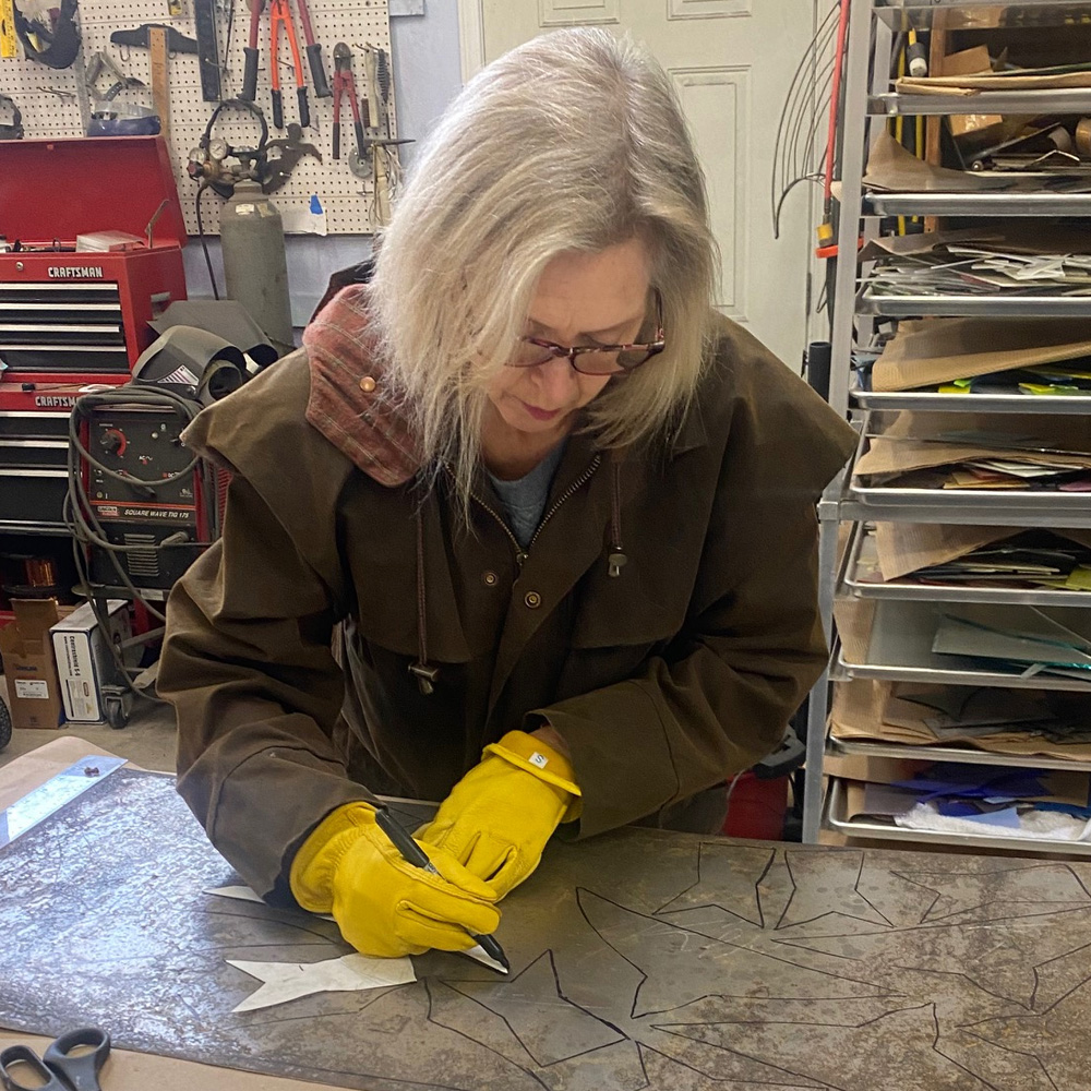 Photo of Cindy Geffel hard at work on another new piece.