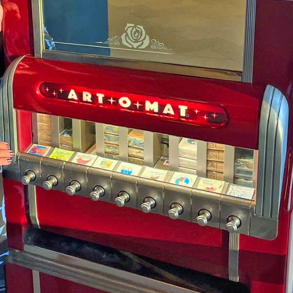 Photo of the Art-o-Mat, a repurposed vintage cigarette pack vending machine in the Broadway Rose lobby that now dispenses miniature art pieces.