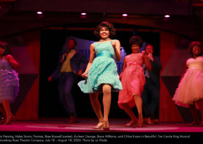 Lydia Fleming, Myles Sturns-Thomas, Bree Boswell (center), Kurleen George, Bryce Williams, and Chloe Evans in Beautiful: The Carole King Musical at Broadway Rose Theatre Company, July 18 – August 18, 2024. Photo by Liz Wade.