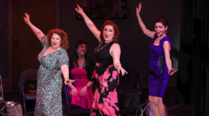 The cast of Audition From Hell dancing across the stage together.