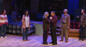 The cast of Snapshots on stage, singing a song together.