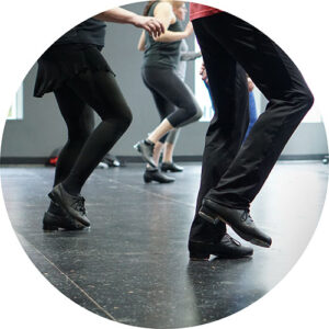 Photo from one of our adult tap classes. Shows a low angle, capturing our students' feet mid shuffle.