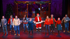 Photo of the cast of Five Golden Rings, spread across the stage during the closing number, singing and dancing together.