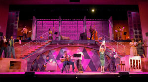 Photo from our 2024 production of Beautiful showing the group number 1650 Broadway Medley with the stage full of singers and dancers performing a medley of 1950s hits.