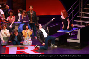 Victor Polanco and Sophie MacKay with the cast of Grease at Broadway Rose Theatre Company, April 10 – May 18, 2025. Photo by Fletcher Wold.