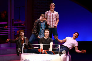 Photo of the greasers singing Greased Lightning, piled into the car.