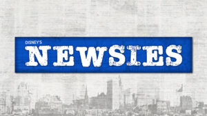 Logo for Newsies. The text is in an old newsprint font surrounded by a bright blue box. Behind that, in the background, it an old photograph of the New York skyline from the early 20th century.