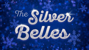 Logo for The Silver Belles. The text is in a glittering silver font over a bold blue background filled with light blue snowflakes.