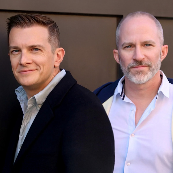 A photo of Thomas Mizer and Curtis Moore, both smiling toward the camera.