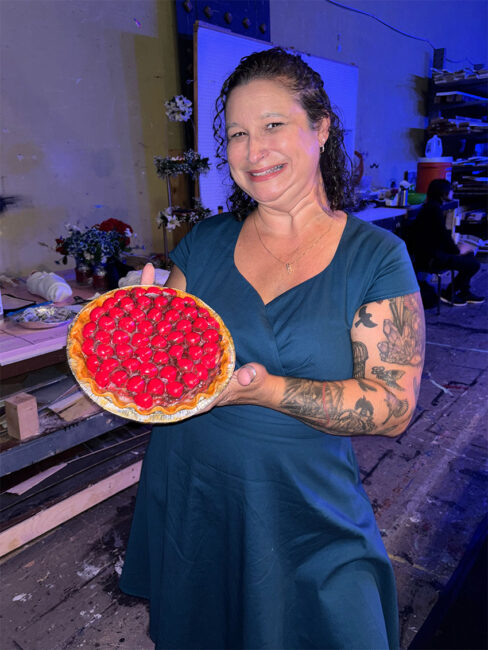 A photo of Jaymie Theissen holding one of the prop pies used in our production of Waitress.