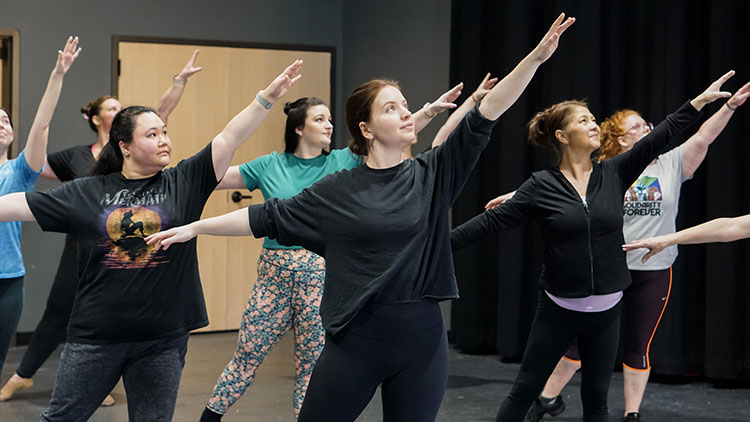 Jazz - Intermediate Advanced A photo of multiple people all posing dramatically with their arms outstretched in one of our adult jazz dance classes.