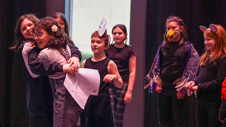 Kids Showcase A photo of kids hugging one another at one of our Kids Showcase performances.