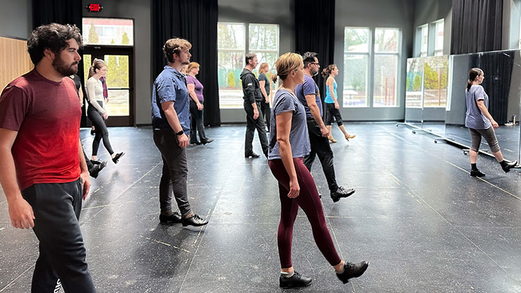 Tap - Beginners A photo from one of our adult tap beginners class showing many students holding out one foot, ready to take their first steps in tap dancing.