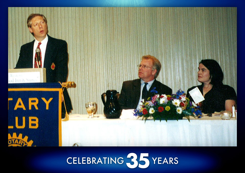 Spotlight 5 - Community A photo f Dan and Sharon at a Tigard Rotary Club event, sitting at the head table as they are honored for their work within the community.