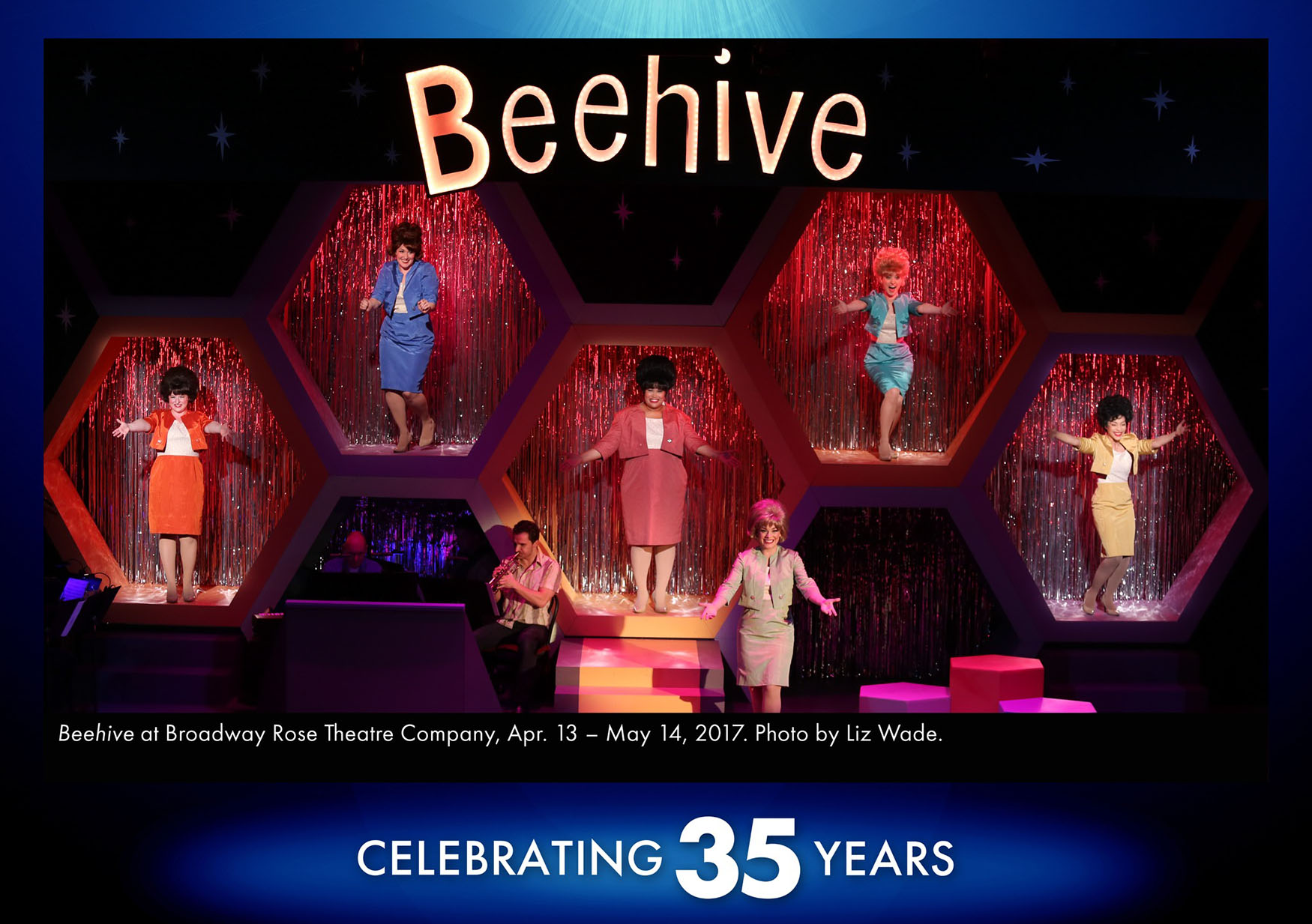 Beehive set A photo of the set of Beehive from 2017. The set is made of a large wall with platforms inside of hexagonal portals, like a beehive mixed with the wall of stars from Hollywood Squares. It's a very 1960s and 1970s themed set to match the style and music of the 1970s period show.