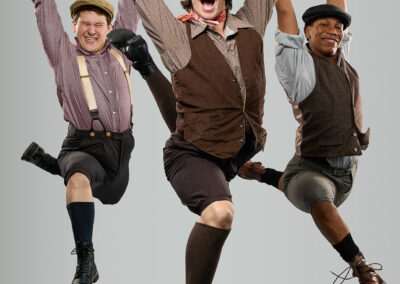 Riley Given, Tyler Grant Luff, and Noah Bleasdell in Newsies at Broadway Rose Theatre Company, July 16 - August 16, 2026. Photo by Fletcher Wold.