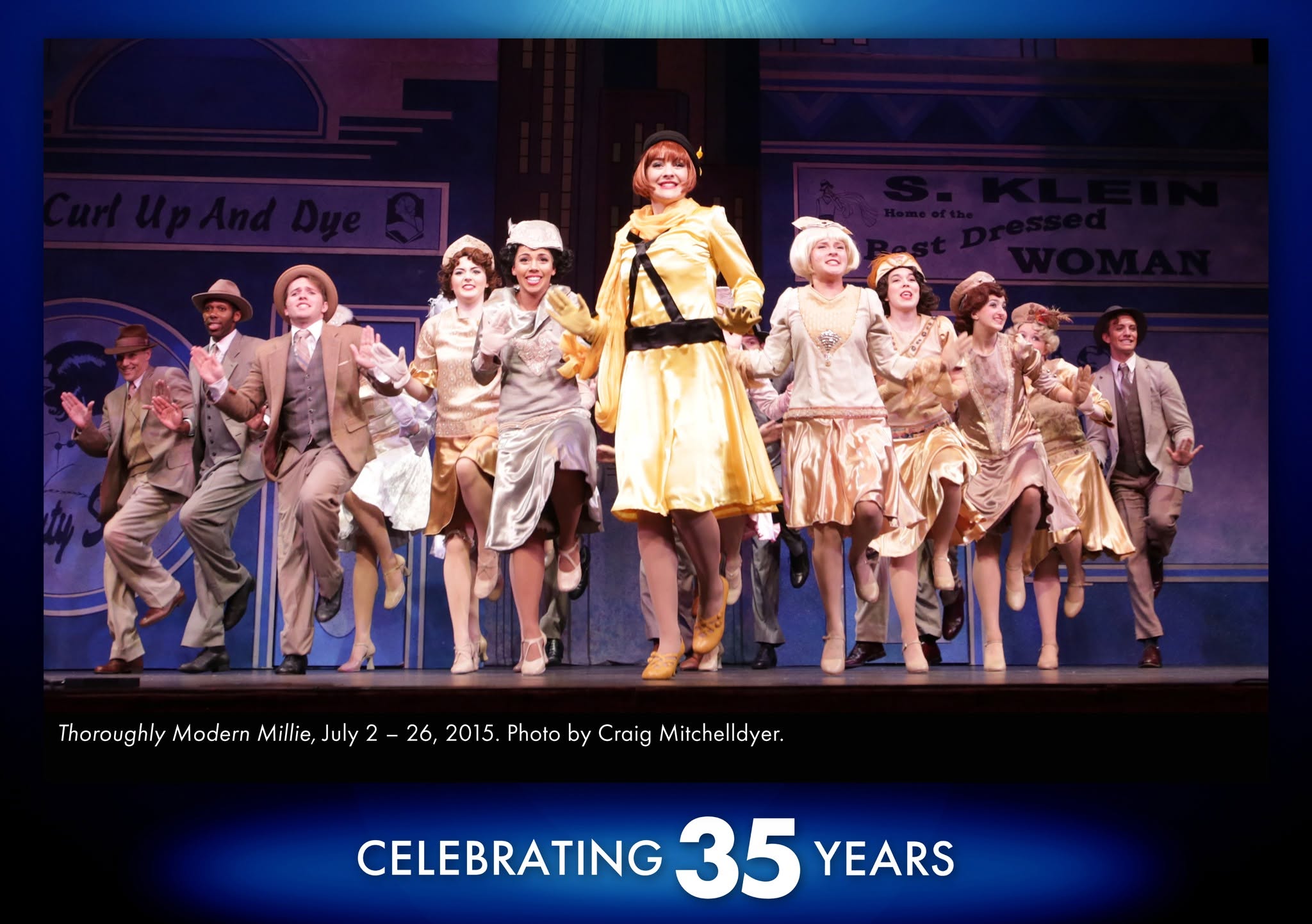 Thoroughly Modern Millie A photo from our production of Thoroughly Modern Millie in 2015 showing Millie and the ensemble in the middle of a stunning dance routine. They are in a V shaped formation pointing toward the front of the stage in a jazz stepping line.